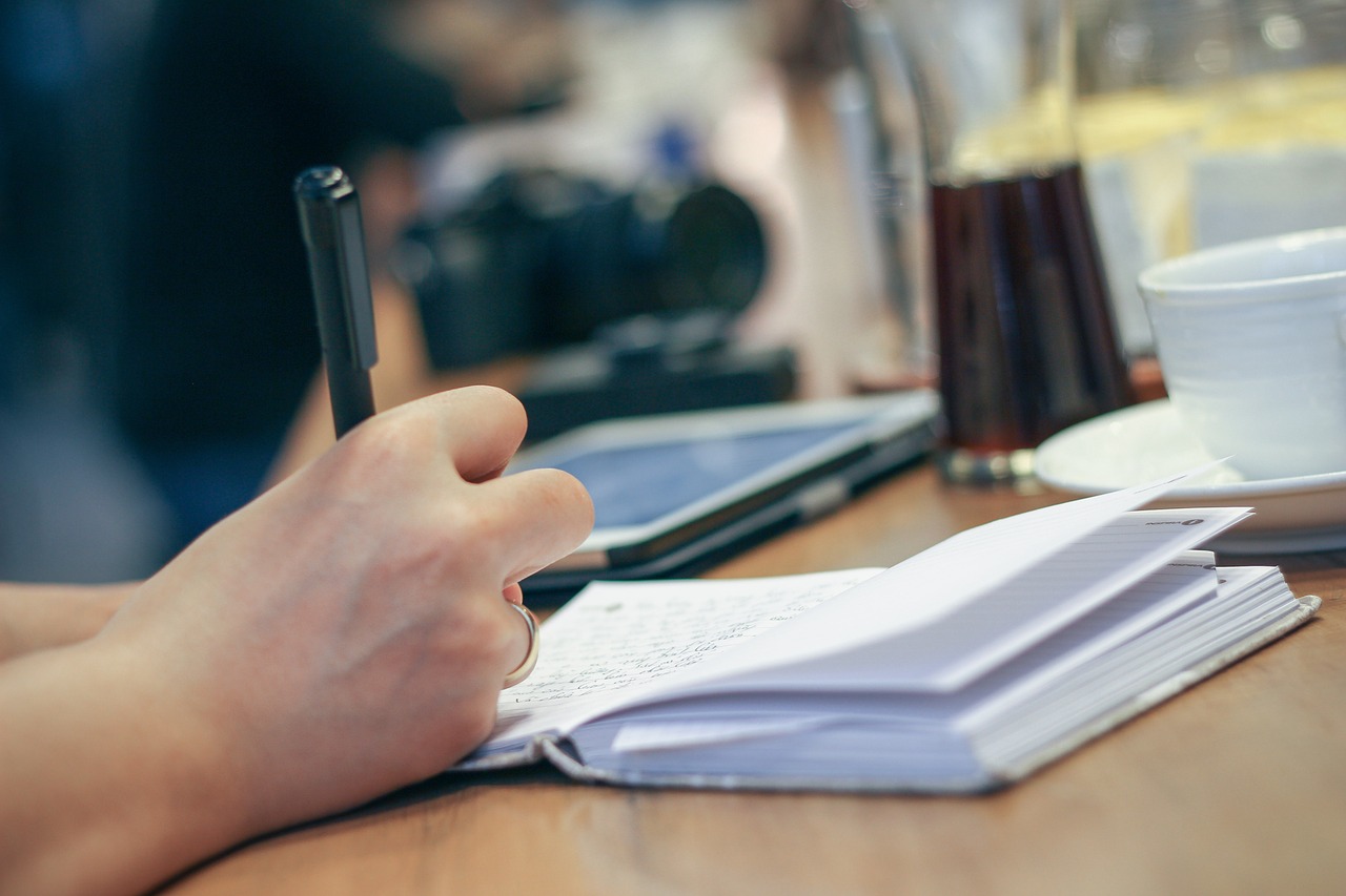 hand write pen notebook journal planner writing paper pages open notebook notes desk person work working writer taking notes write journal writing writing writing writing work work writer writer writer writer writer