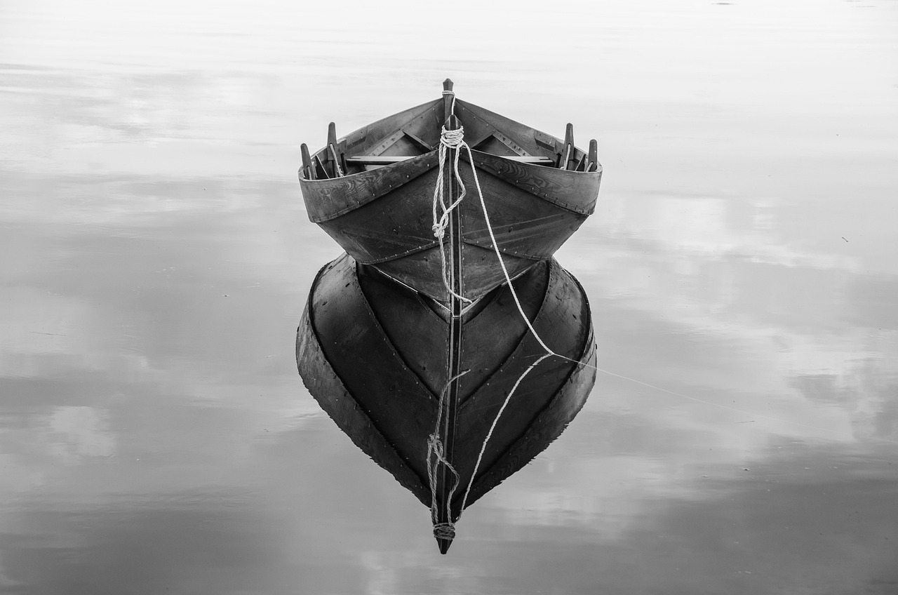 boat water rope lake wooden boat shore anchor reflection nature calm peaceful monochrome